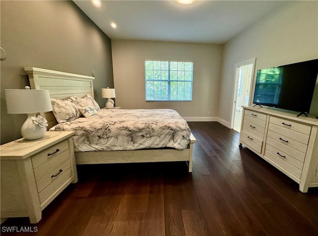 bedroom with dark hardwood / wood-style flooring