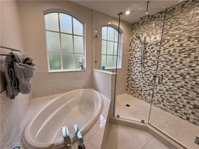 bathroom with tile patterned flooring and plus walk in shower