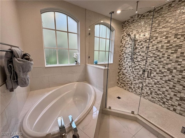 bathroom with independent shower and bath and a wealth of natural light