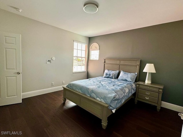 bedroom with dark wood-type flooring