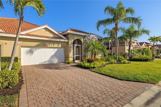 mediterranean / spanish-style house with a garage and a front yard