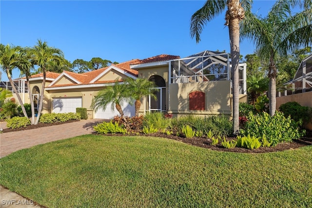 mediterranean / spanish-style home with a garage, a lanai, and a front lawn