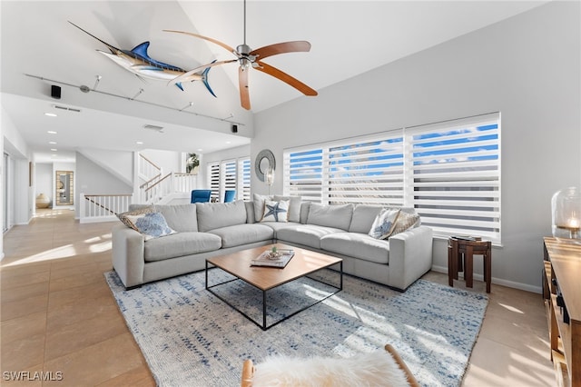 tiled living room with high vaulted ceiling and ceiling fan