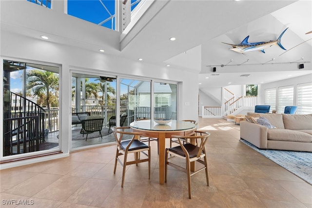 dining area with a towering ceiling and plenty of natural light