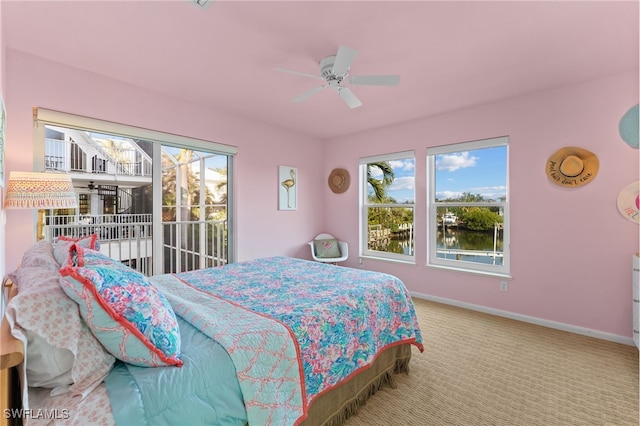 carpeted bedroom featuring access to outside and ceiling fan