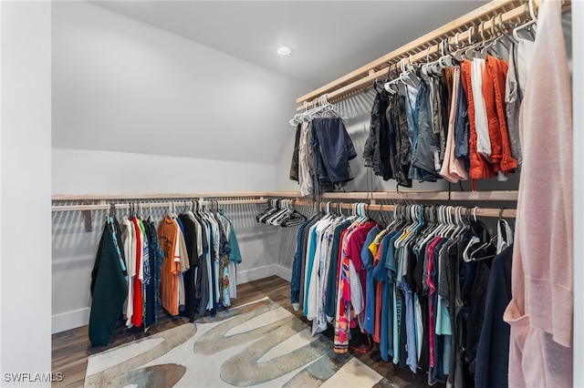 walk in closet featuring hardwood / wood-style floors and lofted ceiling