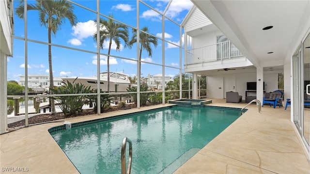 view of pool with a lanai, an in ground hot tub, and a patio