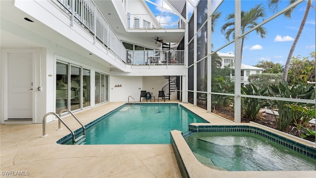 view of swimming pool featuring an in ground hot tub and a patio