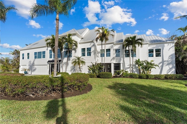 view of front facade with a garage and a front lawn