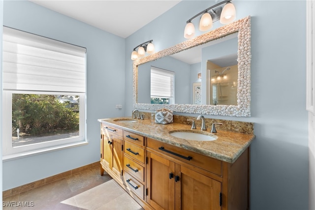 bathroom featuring tile patterned flooring, vanity, and a healthy amount of sunlight