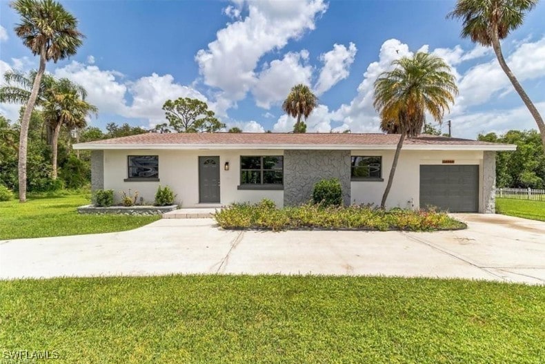 ranch-style house with a front lawn and a garage