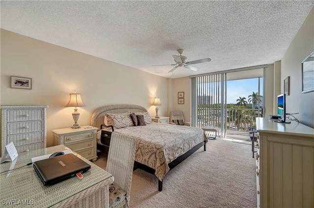 carpeted bedroom with ceiling fan, access to outside, floor to ceiling windows, and a textured ceiling