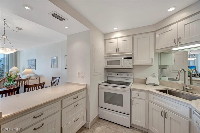 kitchen featuring pendant lighting, sink, white appliances, and white cabinetry