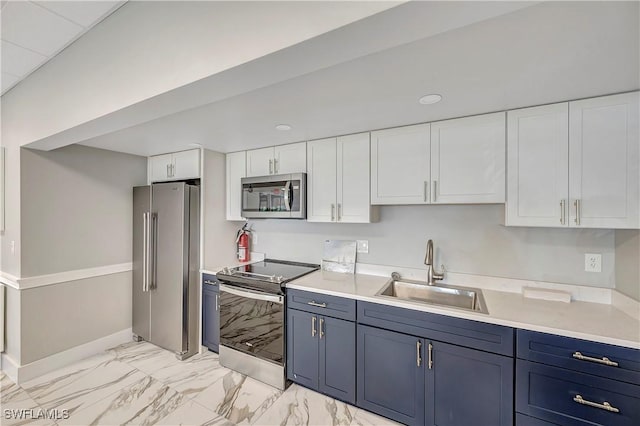 kitchen featuring blue cabinets, appliances with stainless steel finishes, sink, and white cabinets