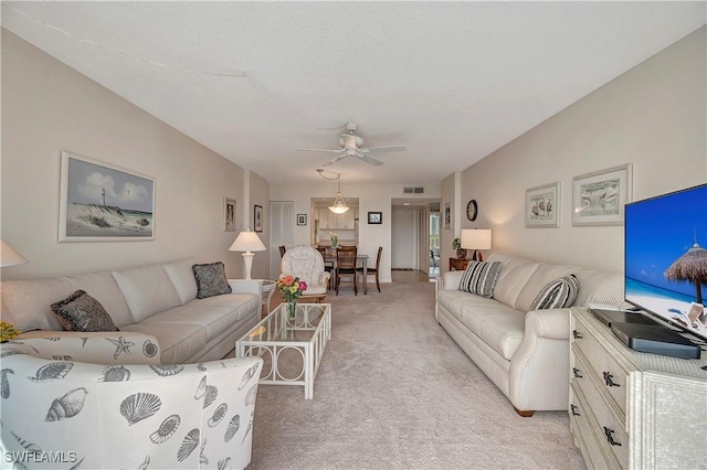 living room featuring light carpet and ceiling fan