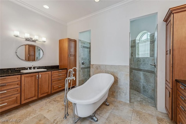 bathroom with vanity, crown molding, tile walls, and independent shower and bath