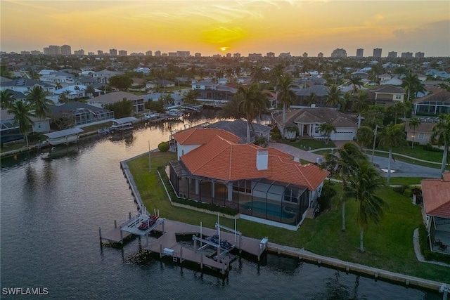 aerial view at dusk with a water view