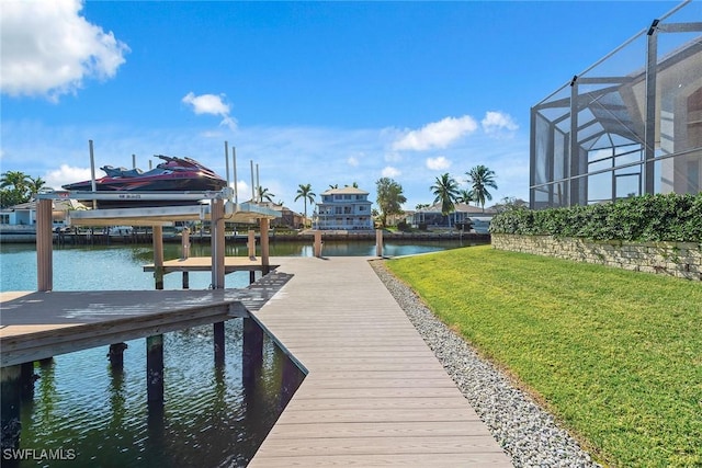 dock area with a lawn and a water view