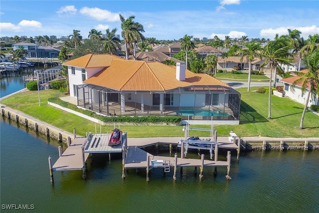 exterior space with a lawn, a lanai, a water view, and a pool