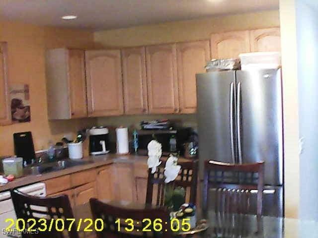 kitchen featuring light brown cabinets and stainless steel refrigerator