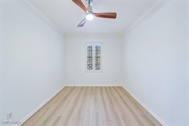 spare room with ornamental molding and light hardwood / wood-style flooring