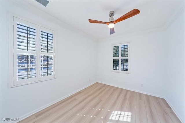 empty room with ceiling fan, light hardwood / wood-style flooring, and crown molding