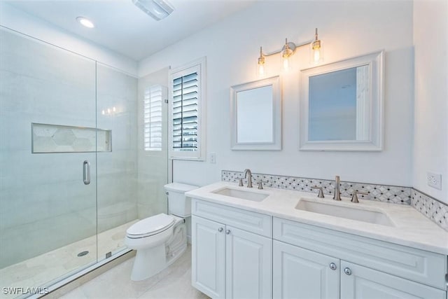 bathroom featuring toilet, tile patterned flooring, walk in shower, and vanity