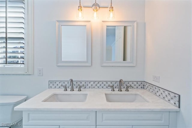 bathroom with toilet and vanity