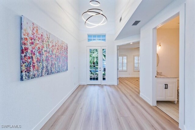 entryway featuring french doors and light hardwood / wood-style floors