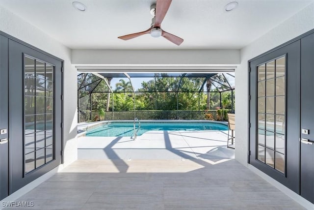 view of swimming pool with a lanai, a patio area, and ceiling fan