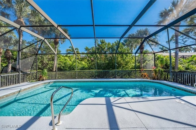 view of pool with glass enclosure