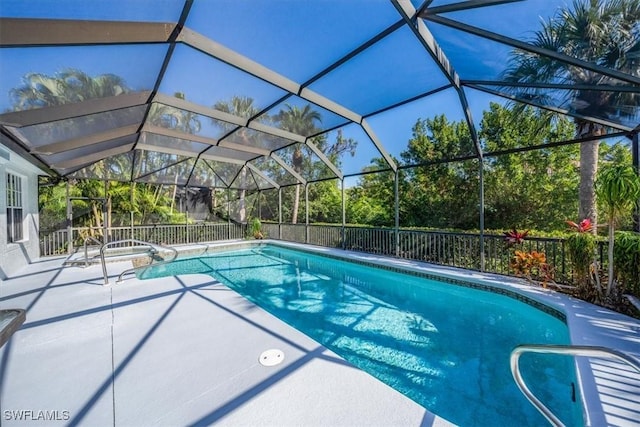 view of pool featuring a patio area and glass enclosure