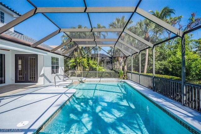 view of pool featuring a lanai, a patio, and french doors