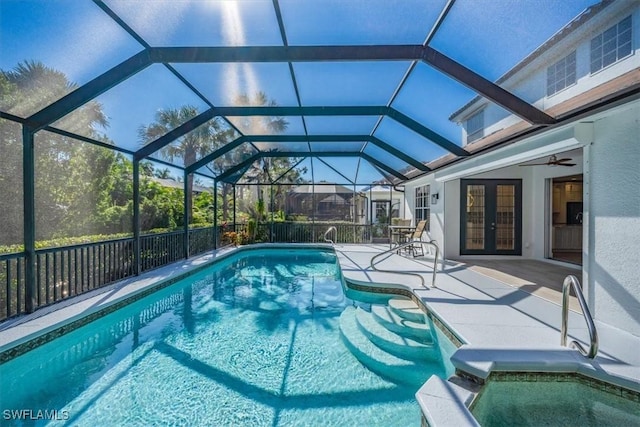 view of swimming pool featuring french doors, a lanai, ceiling fan, and a patio