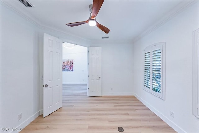 spare room featuring ceiling fan, ornamental molding, and light hardwood / wood-style flooring