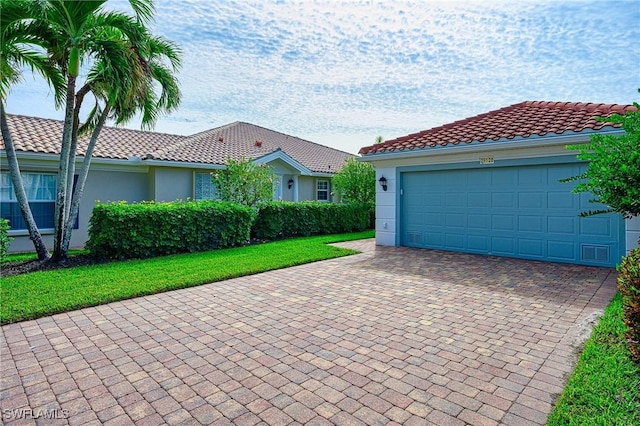 view of front of property with a garage and a front yard