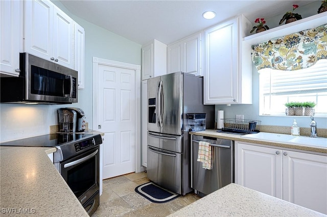 kitchen with white cabinets, sink, and appliances with stainless steel finishes