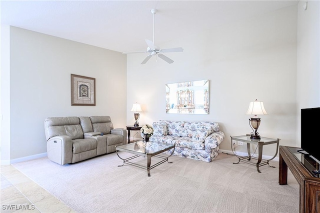 carpeted living room with ceiling fan