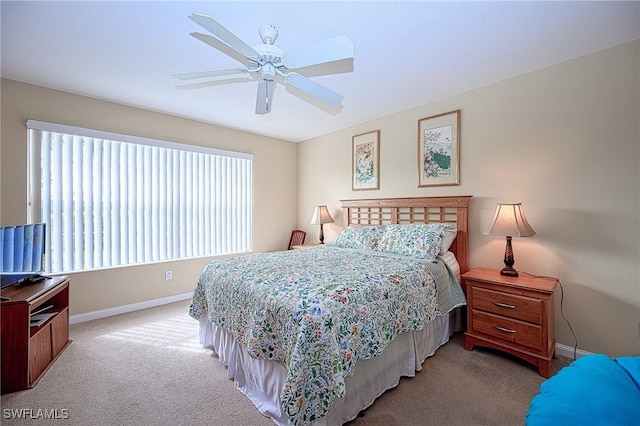 bedroom with ceiling fan and light colored carpet