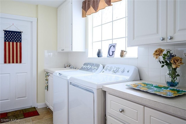 clothes washing area featuring cabinets, sink, and washing machine and clothes dryer