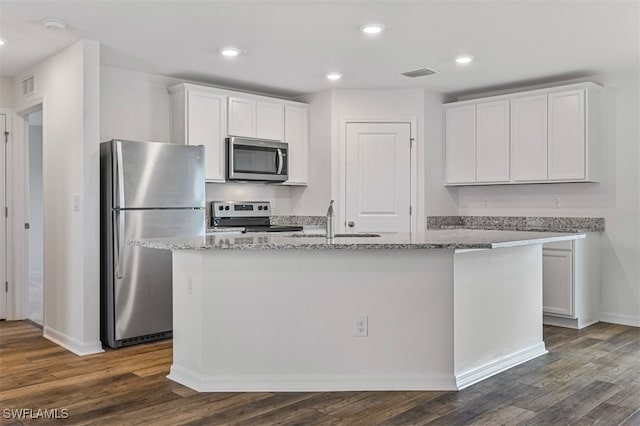 kitchen featuring a center island with sink, white cabinetry, sink, and appliances with stainless steel finishes