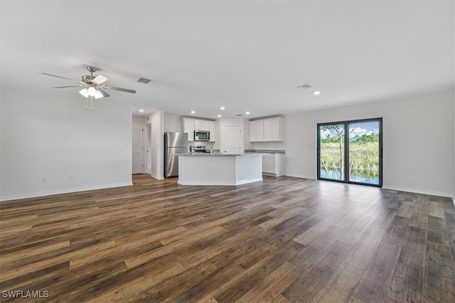 unfurnished living room featuring dark hardwood / wood-style flooring and ceiling fan