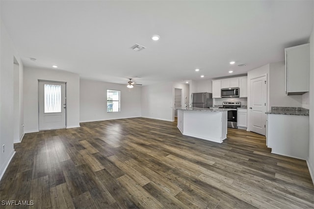 kitchen with ceiling fan, a center island, stainless steel appliances, dark hardwood / wood-style floors, and white cabinets