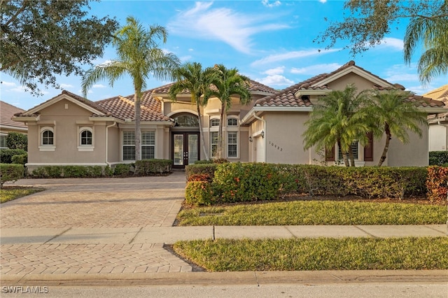 mediterranean / spanish home featuring french doors