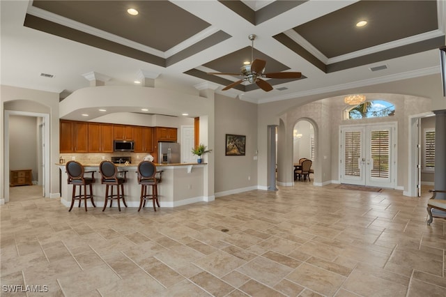 kitchen with french doors, stainless steel appliances, coffered ceiling, kitchen peninsula, and crown molding