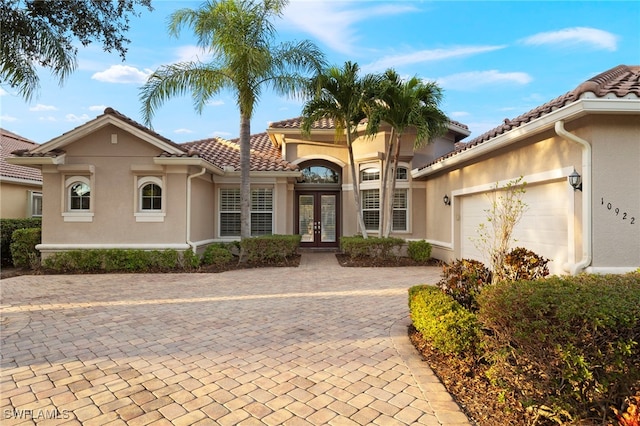 mediterranean / spanish home featuring french doors and a garage