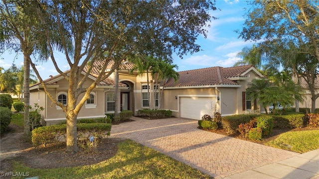 mediterranean / spanish house with a garage