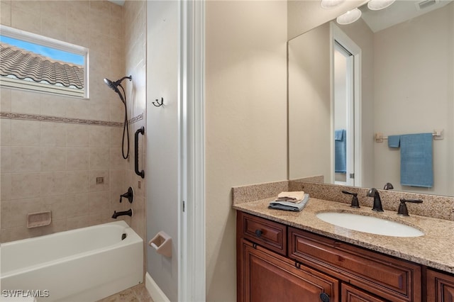 bathroom featuring vanity and tiled shower / bath combo