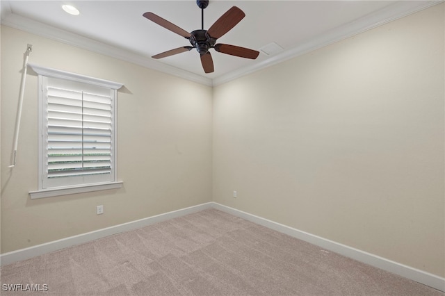 carpeted empty room featuring ceiling fan and crown molding