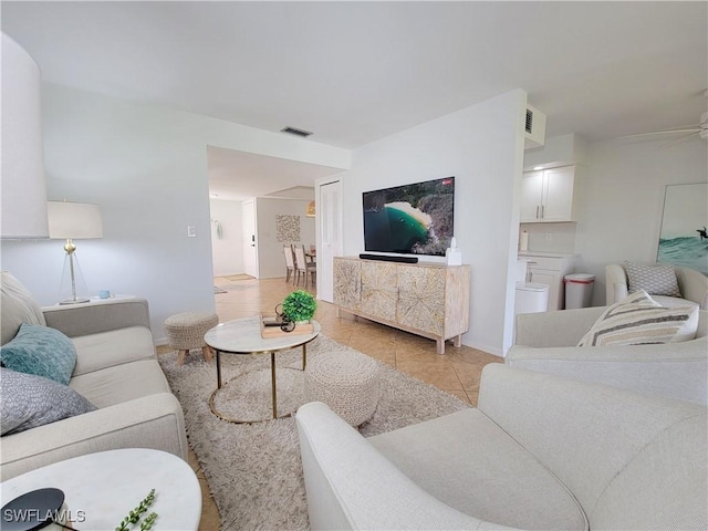 tiled living room featuring ceiling fan